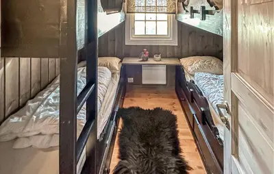 a dog is standing in a room with bunk beds at Stunning Home In Beitostølen With Sauna in Beitostøl