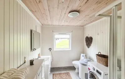 a bathroom with a sink and a toilet and a window at 2 Bedroom Lovely Home In Haugesund in Haugesund