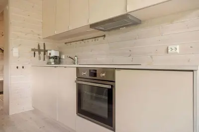 a kitchen with a stove and a counter top at Tiny Mountain Cabin II in Stranda