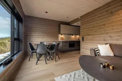 a living room with a table and chairs and a couch at Mountain View Apartment - 205 in Stranda