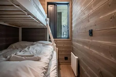 a bunk bed in a room with wooden walls at Mountain View Apartment - 205 in Stranda