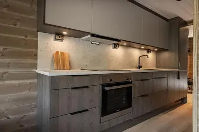a kitchen with a sink and a stove at Mountain View Apartment - 205 in Stranda