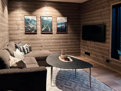 a living room with a couch and a table at Mountain View Apartment - 205 in Stranda