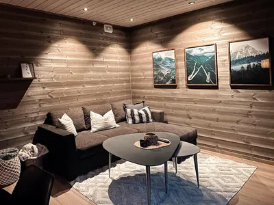 a living room with a couch and a table at Mountain View Apartment - 205 in Stranda