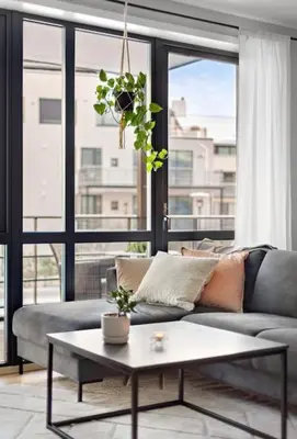 a living room with a couch and a table at Sentral leilighet i Brosundet in Ålesund