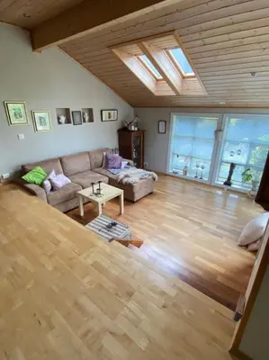 a living room with a couch and a table at Hus med plass til 7 personer til leie in Veka