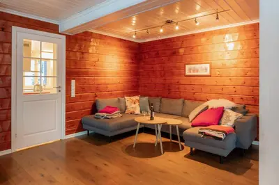 a living room with a couch and a table at Handeland Lodge Near Trolltunga and Pulpit Rock Sleeps 18 with Sauna in Sauda