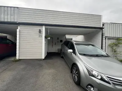 a car parked in front of a garage at Sunny gateaway Room in Lerstad, Suitable for two guests in Ålesund