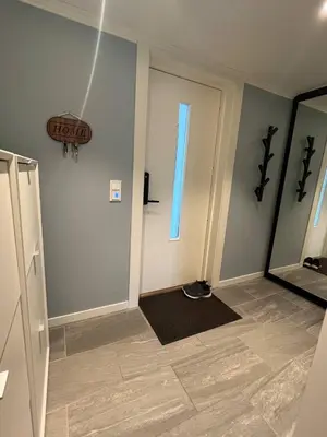 a hallway with a door and a window and a mirror at Sunny gateaway Room in Lerstad, Suitable for two guests in Ålesund