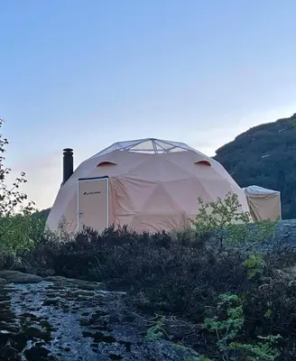a large white tent sitting on top of a hill at Handeland Lodge I Arctic Dome in Sauda