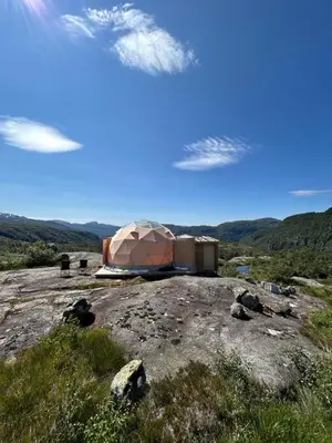 a yurt on top of a hill in a field at Handeland Lodge I Arctic Dome in Sauda