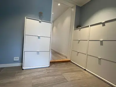 a room with a large white closet with a door at Cozy Urban Single Room in Ålesund