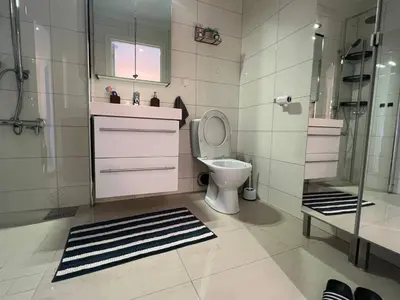 a bathroom with a toilet and a shower at Cozy Urban Single Room in Ålesund