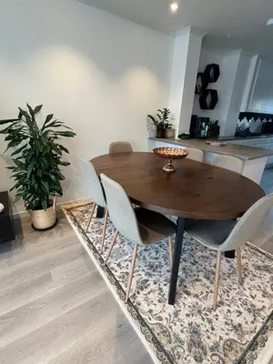 a wooden table and chairs in a living room at Cozy Urban Single Room in Ålesund