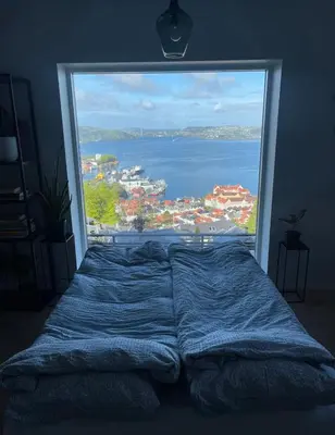 a large window in a bedroom with a large bed at Unique apartment with fantastic views in Bergen