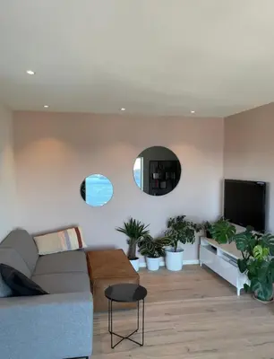 a living room with a couch and a flat screen tv at Unique apartment with fantastic views in Bergen