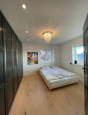 a bedroom with a bed and a chandelier at Unique apartment with fantastic views in Bergen