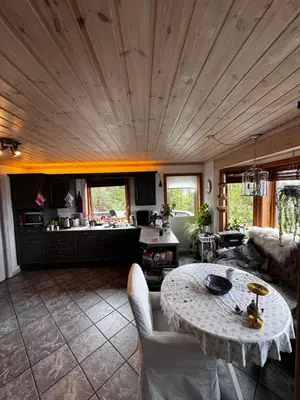 a living room with a table and a kitchen at Villa with a view in Morviki