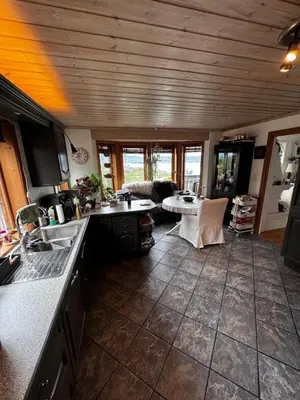 a kitchen with a counter top and a living room at Villa with a view in Morviki