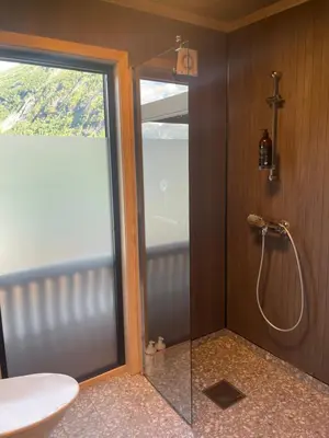 a bathroom with a shower with a glass door at Stryn Golden Resort - Panorama I in Stryn