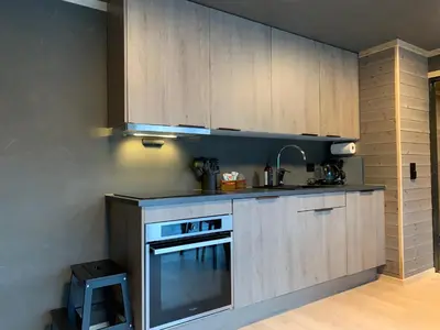 a kitchen with white cabinets and a stove top oven at Stryn Golden Resort - Panorama II in Stryn