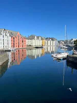a harbor with a sail boat in the water at Ålesund sentrum Parkgata in Ålesund