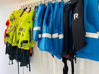 a group of jackets hanging on a rack at 6 person holiday home in BØMLO in Bømlo
