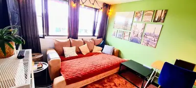 a bedroom with a bed with a red blanket at Karmo in Trondheim