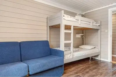 a living room with a couch and a bunk bed at Hytte med sentral beliggenhet in Trysil