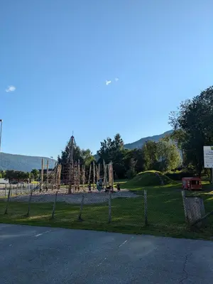 a playground in a park with a roller coaster at Liten leilighet midt i sentrum in Stryn