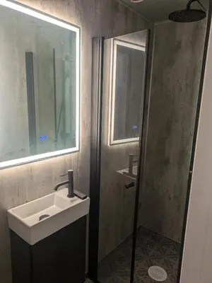 a bathroom with a sink and a mirror at Liten leilighet midt i sentrum in Stryn