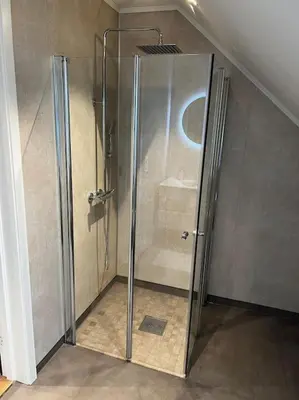 a shower with a glass door in a bathroom at Nytt hus i fredfullt nabolag in Verdal
