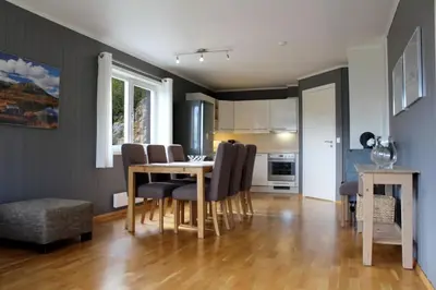 a kitchen and dining room with a table and chairs at Hemsedal, Ski in Ski out, Skarsnuten Panorama 55 in Tuv