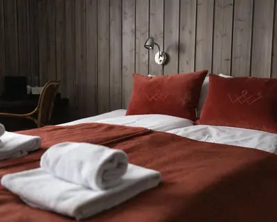 a bed with towels and pillows on top of it at Danebu Kongsgaard - Boutique Hotel in Aurdal