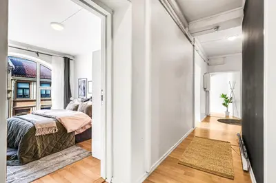 a bedroom with a bed in a room with a hallway at 3-Bedroom - Heart of Trondheim Center in Trondheim