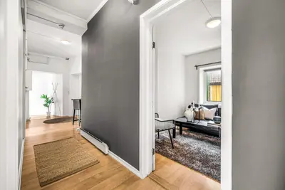 an open hallway leading to a living room with a couch at 3-Bedroom - Heart of Trondheim Center in Trondheim