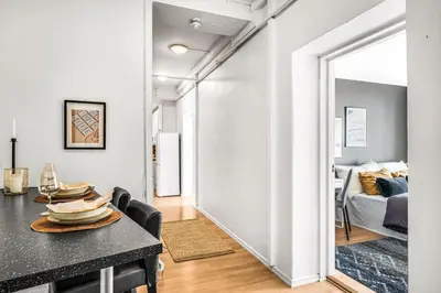 a dining room with a table and a living room at 3-Bedroom - Heart of Trondheim Center in Trondheim