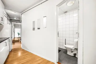 an open bathroom with a toilet and a mirror at 3-Bedroom - Heart of Trondheim Center in Trondheim