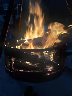 a large grill with fire inside of it at Old Town House in Rjukan