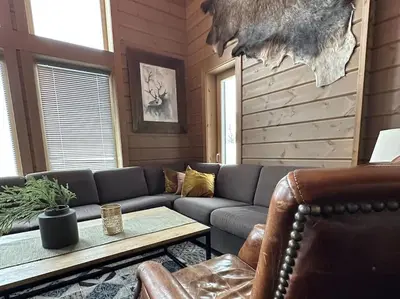 a living room with a couch and a table at Myrkdalen Lodge II, luxury family cabin ski in and out in Helgatun