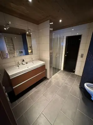 a bathroom with a tub and a sink and a mirror at Myrkdalen Lodge II, luxury family cabin ski in and out in Helgatun