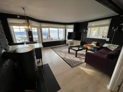 a living room with a couch and a tv at Cozy apt with a view in Beitostøl