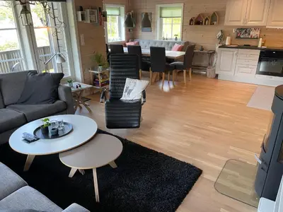 a living room with a couch and a table at Modern, lovely holidayhome, in quiet nature close to Trolltunga in Utsikten