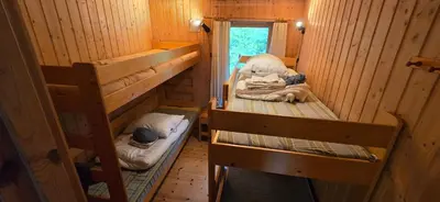 a room with two bunk beds in a cabin at Utsikten in Korsnes