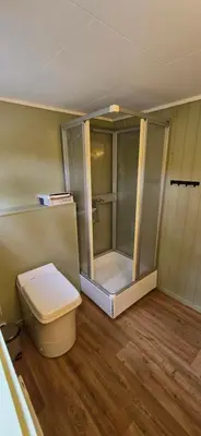 a bathroom with a toilet and a shower at Utsikten in Korsnes
