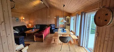 a living room with a couch and a table at Utsikten in Korsnes