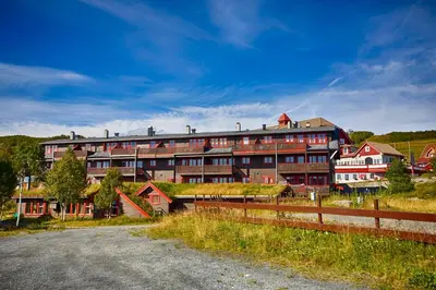 a large building with a road in front of it at Ideal For Families And Groups Near Ski Slopes And Amenities in Beitostøl