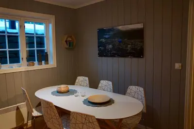 a dining room table with a white table and chairs at Ideal For Families And Groups Near Ski Slopes And Amenities in Beitostøl