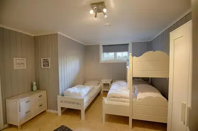 a bedroom with two bunk beds and a window at Ideal For Families And Groups Near Ski Slopes And Amenities in Beitostøl