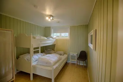 a room with two bunk beds and a window at Ideal For Families And Groups Near Ski Slopes And Amenities in Beitostøl